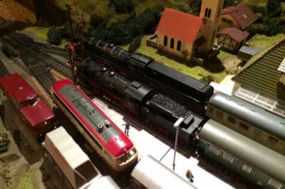 BR 280 and BR 218 diesels and BR 18 and BR 10 steam locomotives in the station.